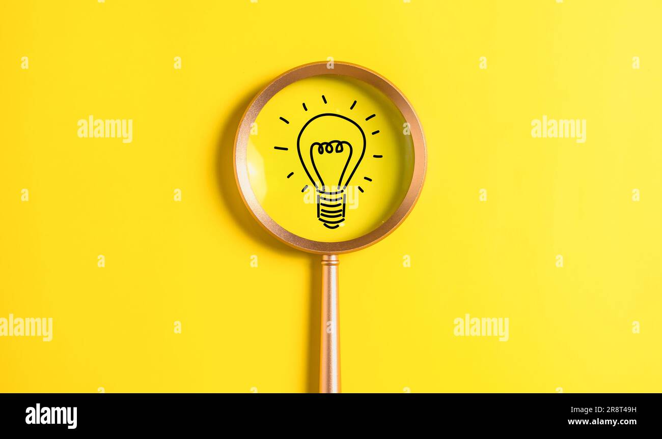 idea light bulb icon on magnifying glass. idea and new design concept on clean background. Stock Photo