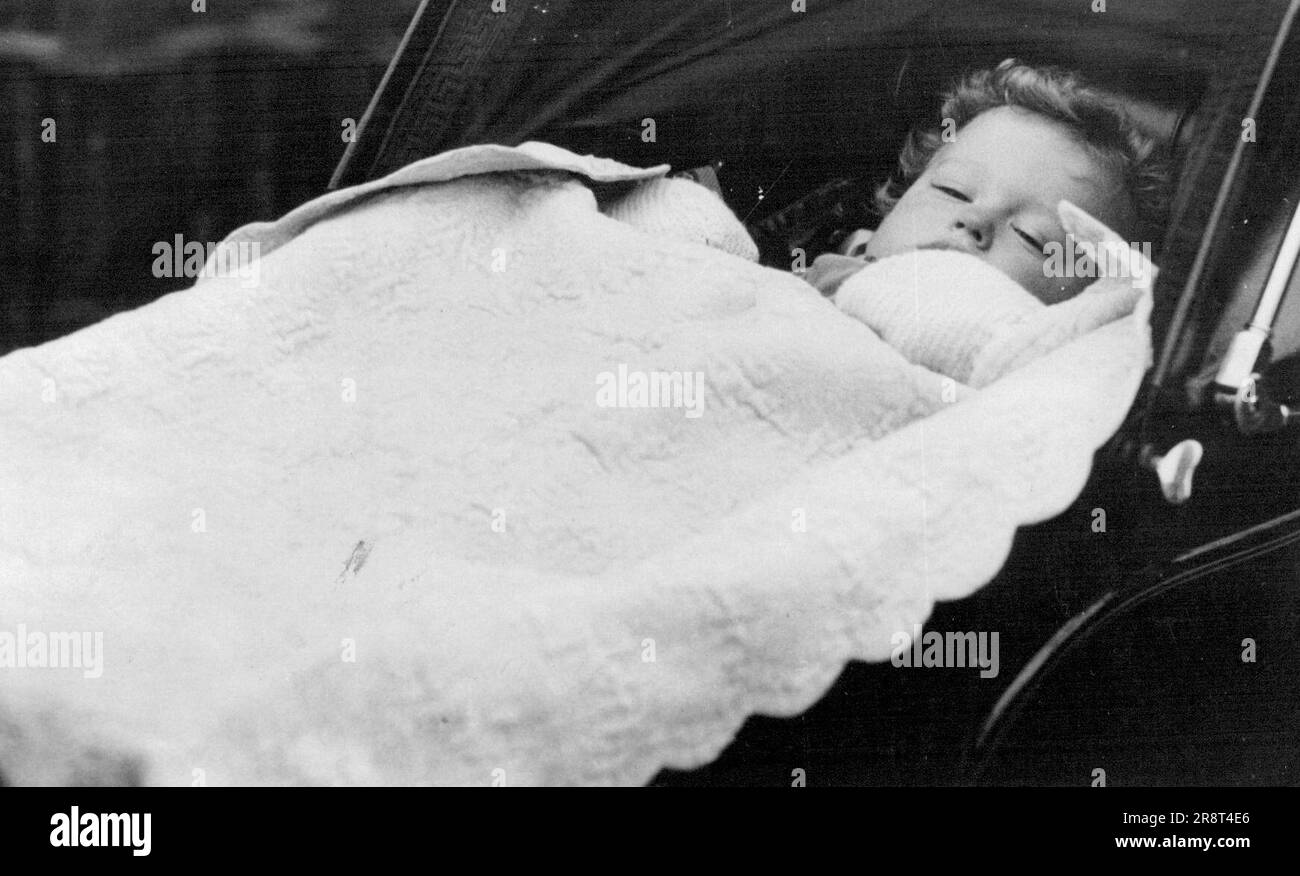 His Royal Richnees Peacefully Asleep - Princes Edward, the Duke and Duchess of Kent's son, knows nothing and cares nothing or what is going on around him in this big city, but peacefully sleeps during his outing this morning in Belgrave Square. January 27, 1937. (Photo by Keystone). Stock Photo