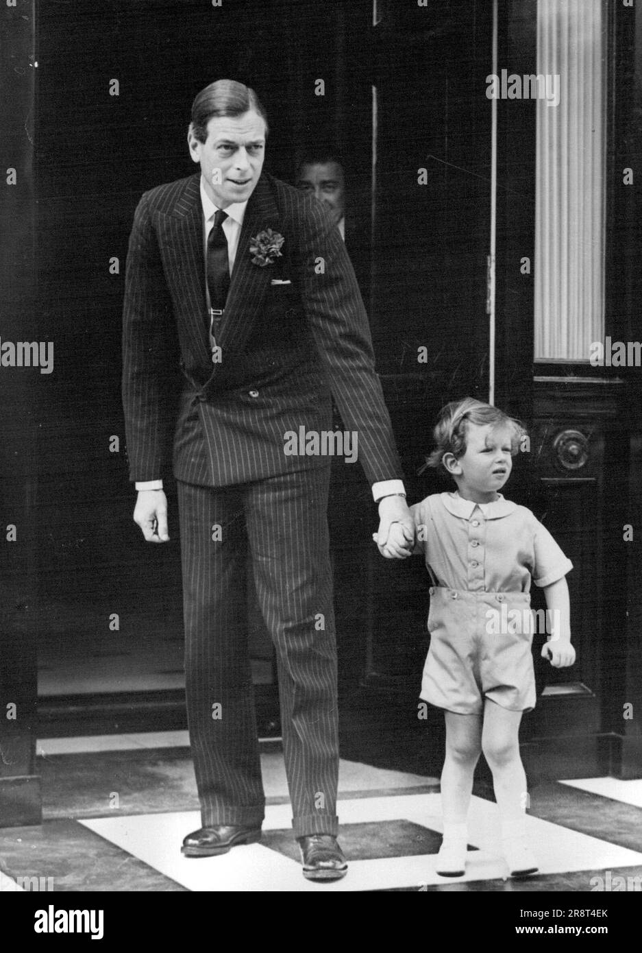 Royal Father and Son See Guests Off After Luncheon - The Duke of Kent with his son, Prince Edward seeing some of their guests off from their home in Belgrave Square after the Luncheon. The Duke and Duchess of Kent entertained friends to a Luncheon Party today after they had attended the ceremony of the trooping the colour. June 9, 1938. (Photo by Keystone). Stock Photo