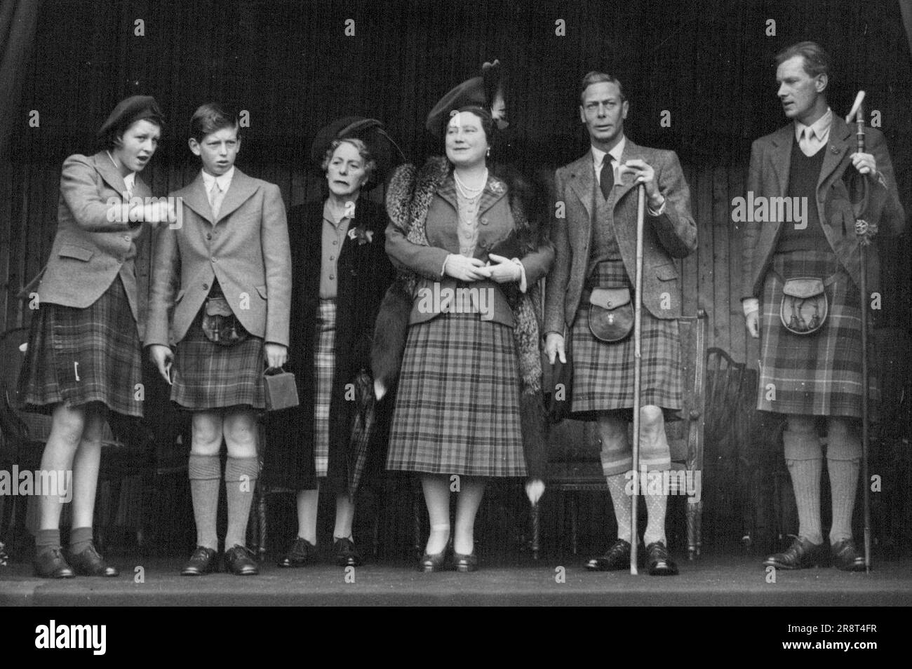 The King And Queen Attend Braemar Gathering - Left to right: Princess Alexandra of Kent, the Duke of Kent, Marchioness of Aberdeen and Temair, H.M. The Queen (wearing a skirt of Hunting Stet Tartan with dark blue tweed jacket), H.M.The King, also in Highland, dress, and Captain Alwyne A. Compton, of Invercauld, watching the Games. The King and Queen - holidaying in Scotland - attended the Braemar Gathering, the famous Scottish sports meeting and which this year attracted nearly 30,000 spectators including many visitors from abroad. September 9, 1948. (Photo by Sport & General Press Agency… Stock Photo