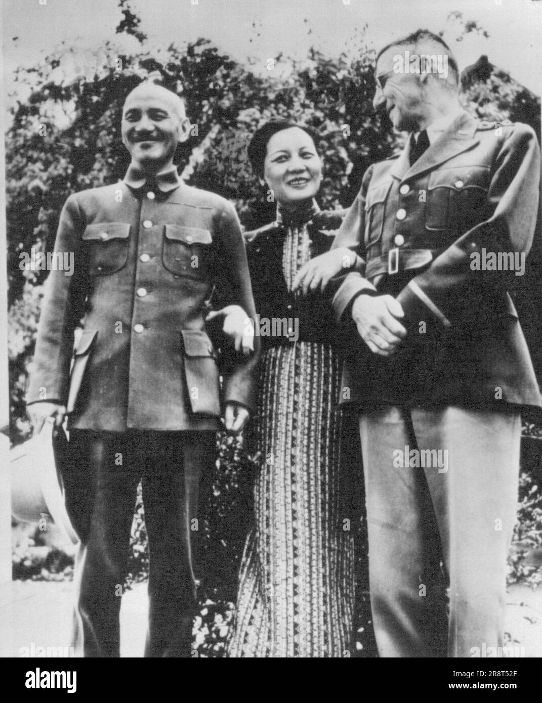 Arm In Arm -- Madame Chiang Kai-Shek stands arm in arm between her husband, the Generalissimo, and General Joseph Stilwell (right), after their conference in Maymyo, April 7, when Chiang Kai-Shek told his Chinese military leaders that the American general was to be their boss in Burma front. May 15, 1942. (Photo by George Rodger, AP Wirephoto). Stock Photo