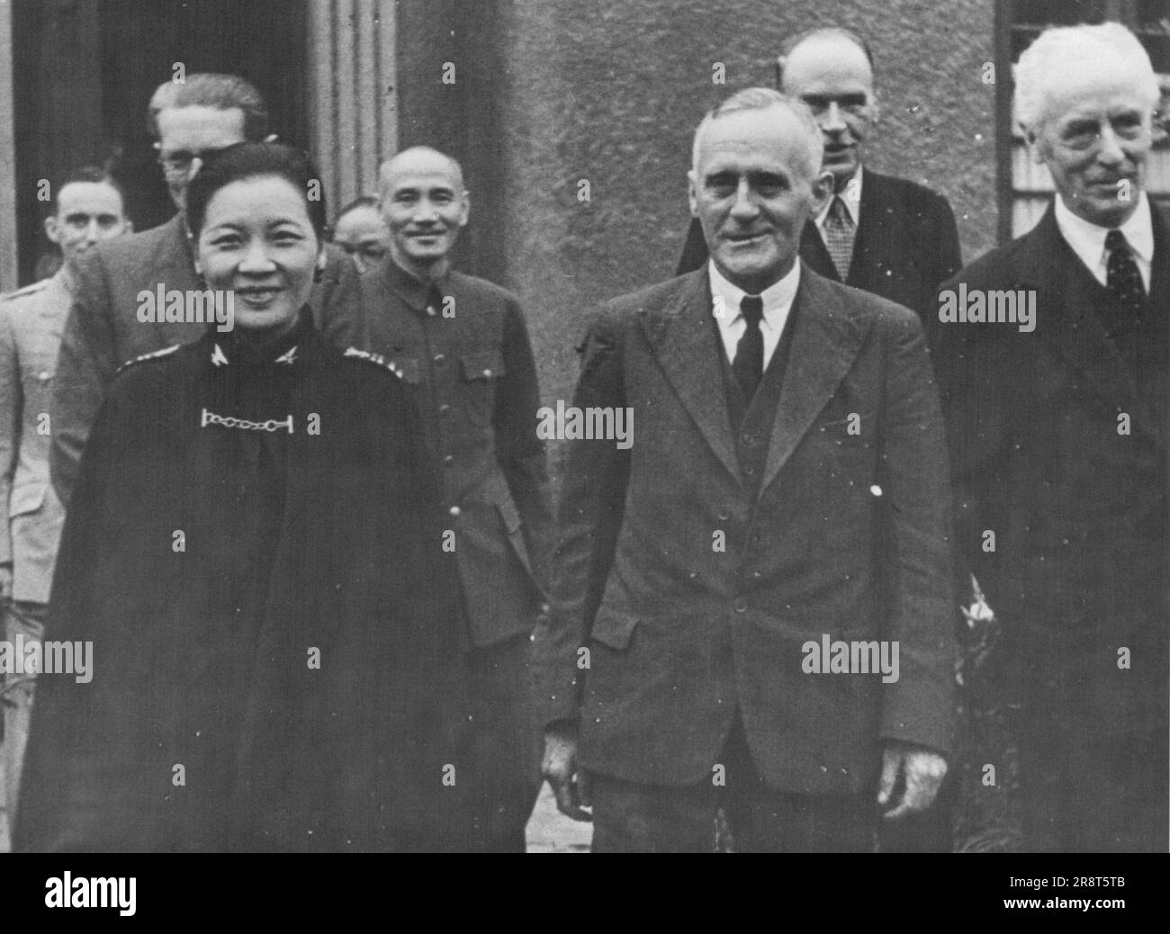 British Parliamentary Mission Visits Chungking At Invitation Of Generalissimo -- Members of the British Mission with the Generalissimo and Madame Chiang Kai Shek in Chungking. L. to R. beginning at 2nd from left - Lord Ailwyn, Madame Chiang Kai Shek, Generalissimo Chiang Kai Shek, Mr. Jack Lawson, Sir Horace Seymour (the British Ambassador in Chungking) and Lord Teviot. At the invitation of the Geralissimo Chiang Kai Shek, a British Parliamentary Mission visited Chungking. It is made up of Lord Ailwyn and Lord Teviot chosen by the Lord Chancellor to represent the House of Lords, and Capta… Stock Photo