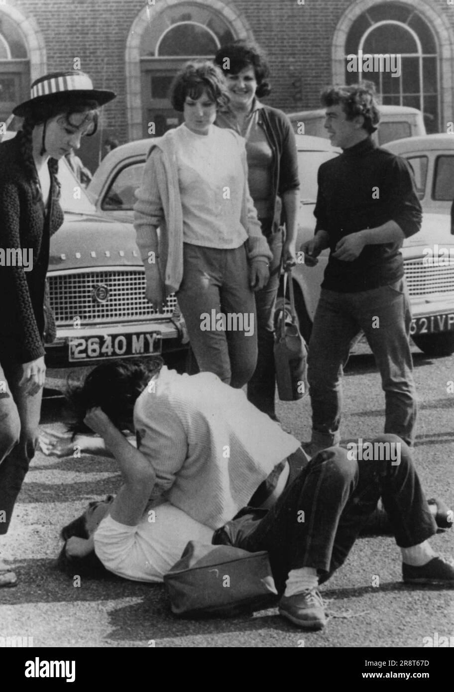 "Wild Ones" At It AgainAs other grinning teenagers watch, two girls fight on the ground during