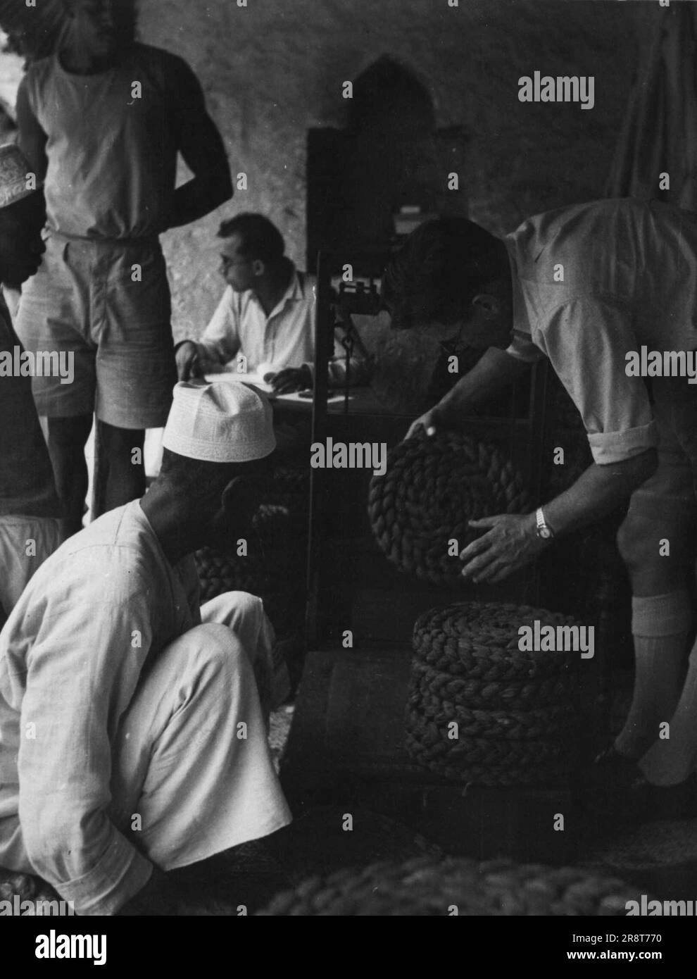 'Native Grown Tobacco in Zanzibar' -- The tobacco is weighed examined and bought by the Clove growers Association at a fair price. Local Tobacco is grown by the country people of Local Tobacco is grown by the country people of Zanzibar and is exported, mainly as chewing tobaccos to British Somaliland. In 1944, fifty two tons were exported by the Glove Growers, Association of Zanzibar. This associated is a corporate body operating under a government decree designed to protect the clove growers and the industry. January 01, 1951. (Photo by British Official Photograph). Stock Photo