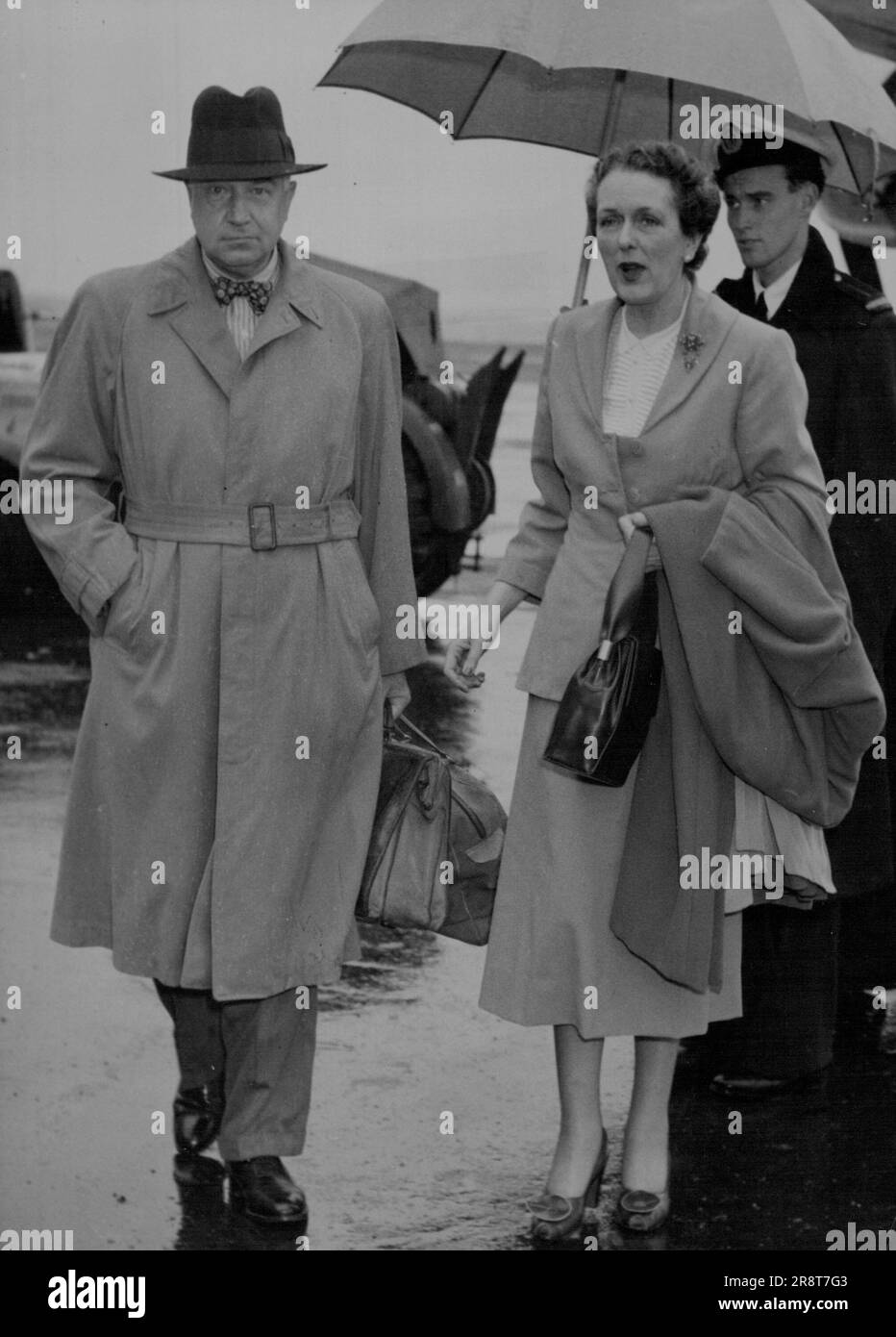 Sir Miles and Lady Thomas arriving at mascot today. Thomas is the Chairman of Director of BOAC. January 4, 1950. (Photo by Kenneth Charles Redshaw/Fairfax Media). Stock Photo