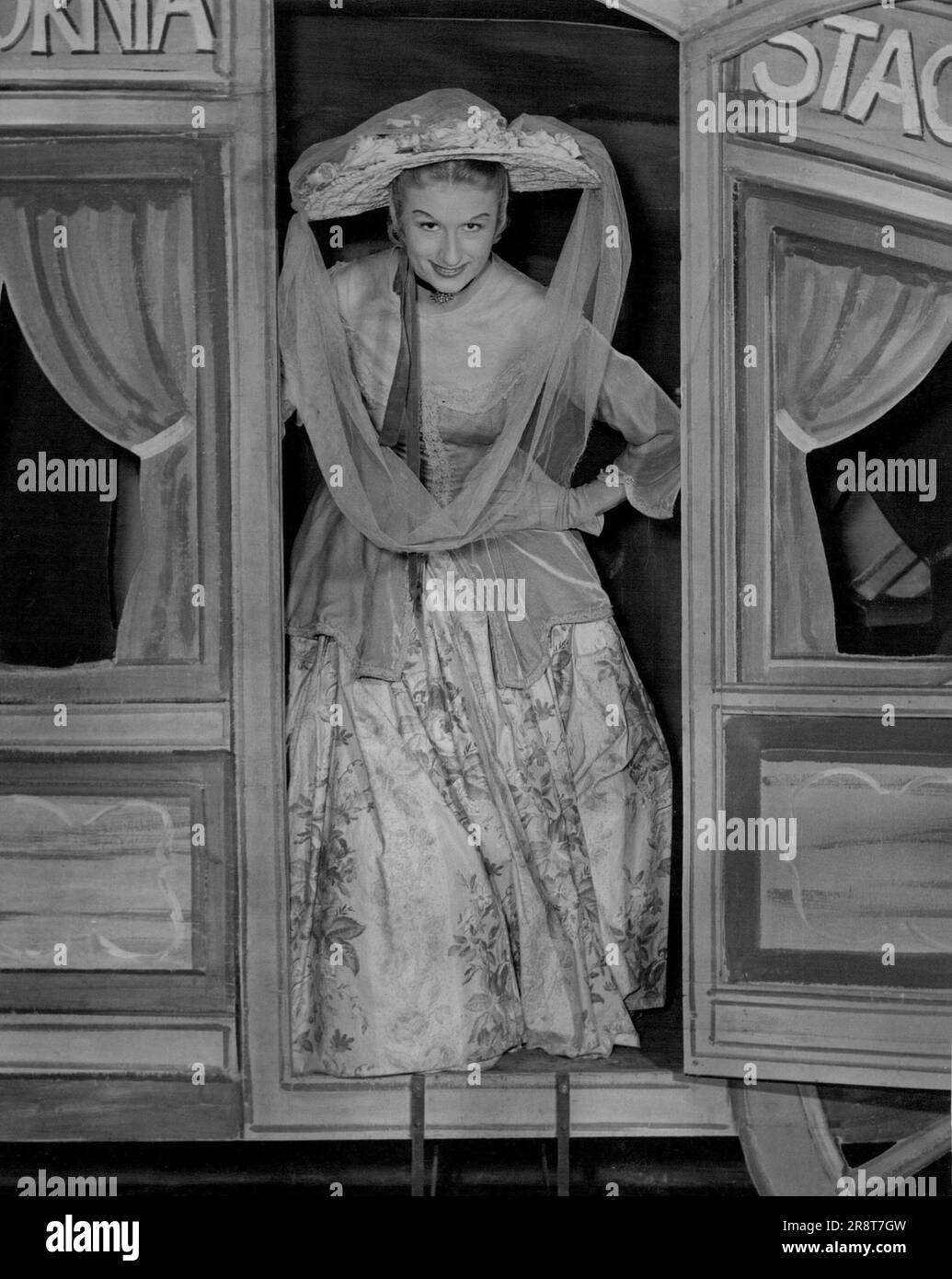Winsome girl, Adele Jarrett, of Brighton (Vic.), has a large floral picture hat and a lime-green veil. July 16, 1955. Stock Photo