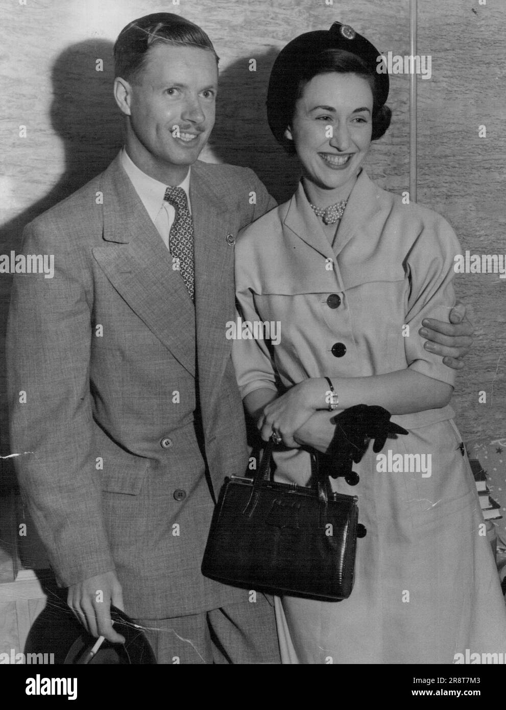 When the Himalaya berthed in Sydney this morning, Bill Tilley was waiting to greet his fiancee, Johneen Johnston, daughter of the S. A. Johnstons, of Neutral Bay. Bill, son of Mr. Frank Tilley, chairman of the Sydney Stock Exchange, and Mrs. Tilley, flew back from Melbourne where he met Johneen, who is wearing a most unusual ring-a huge oblong aquamarine, with diamond shoulders. November 7, 1949. Stock Photo