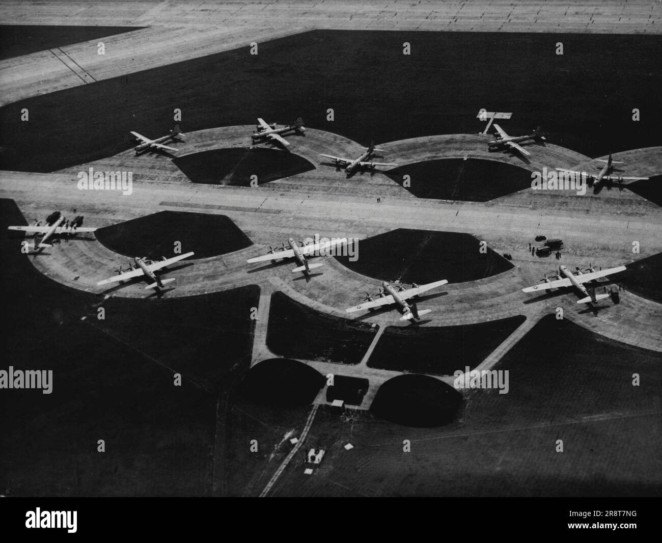Pattern or Air Might: Spaced on the dispersals at Marham Aerodrome, Lincolnshire, are ten United States Boeing 29 Super Fortresses, pictured from the air today, July 17. These aircraft are some of the sixty Superforts which flew in to three Lincolnshire Airfields today on what is described as a 'Normal long-range Traing Flight'. With attendant sky-master transports carrying ground crew and equipment, they made up the biggest air fleet ever to cross the Atlantic in peace-time. They will remain in Britain for several weeks before flying on to Germany. July 29, 1948. (Photo by Associated Pre… Stock Photo