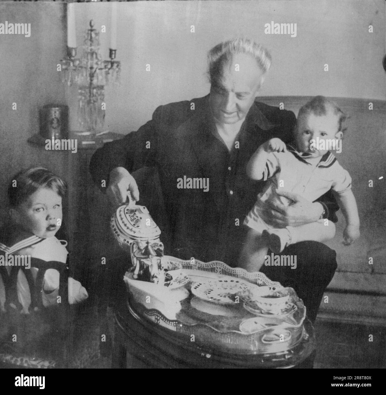 Conductor Leopold Stokowski, shown with his sons now aged 5 and 3 years, is nearly 70. His 1945 marriage with Gloria Vanderbilt has ended. December 28, 1955. Stock Photo