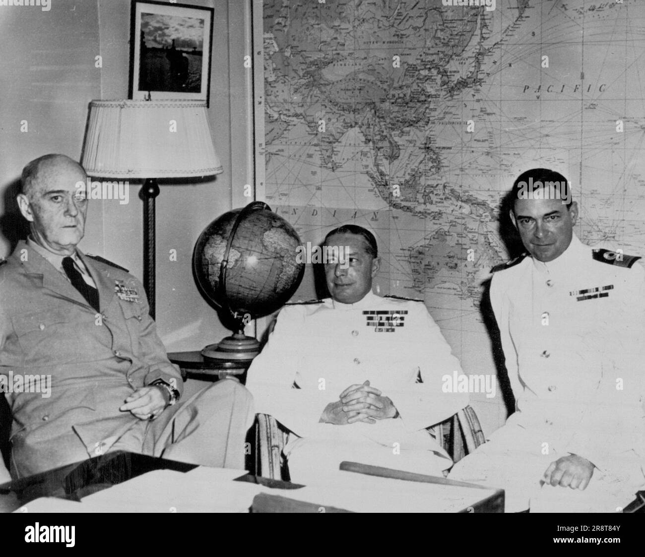 Anzus Talks - Admiral Felix B. Stump, USN, left, Commander in Chief, Pacific and U.S. Pacific Fleet; Vice Adm. Sir John Collins, Royal Australian Navy, center, and Commodore Sir Charles Madden, Royal Navy, who represented New Zealand are pictured as they began closed session talks Dec. 10 at Pacific Fleet headquarters, Pearl Harbor, Hawaii. Admiral Stump. 'fire back.' December 13, 1953. (Photo by U.S. Navy Photo). Stock Photo