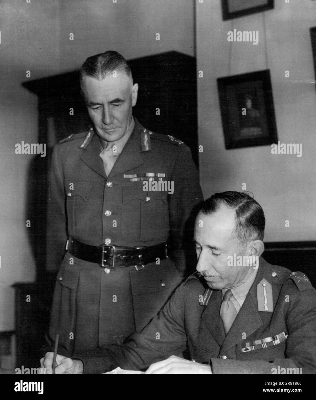 Army Leaders Confer Today - Lieut.-General Sturdee (standing), newly-appointed Commander of the 8th Division A.I.F., and Major-General Miles, who succeeds to the post of General Officer Commanding Eastern Command (N.S.W.), photographed today at Victoria Barracks. June 17, 1940. Stock Photo