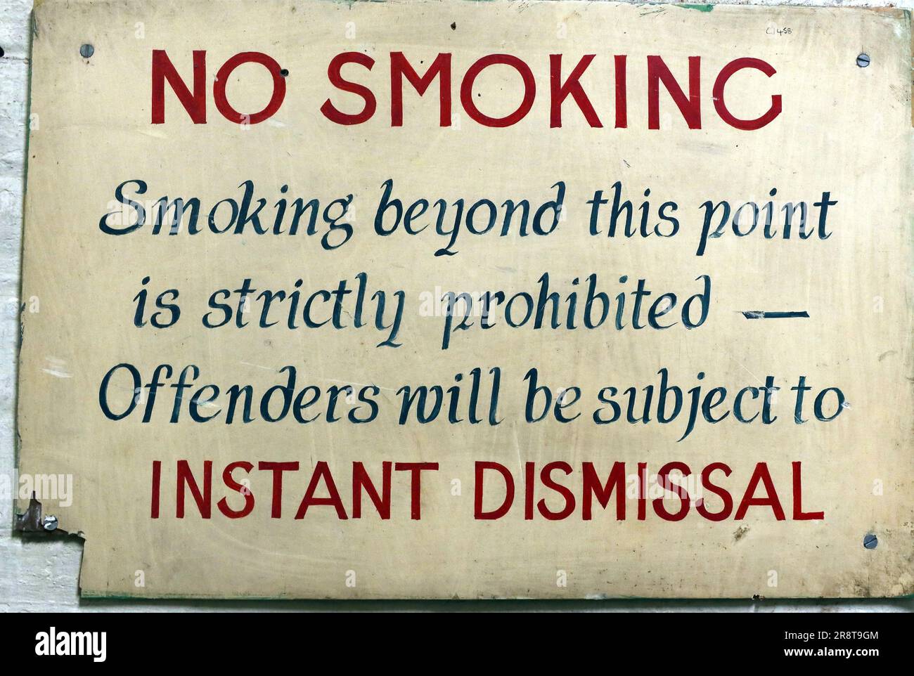Factory No smoking sign - beyond this point is strictly prohibited - offenders will be subject to instant dismissal, Leigh , UK Stock Photo