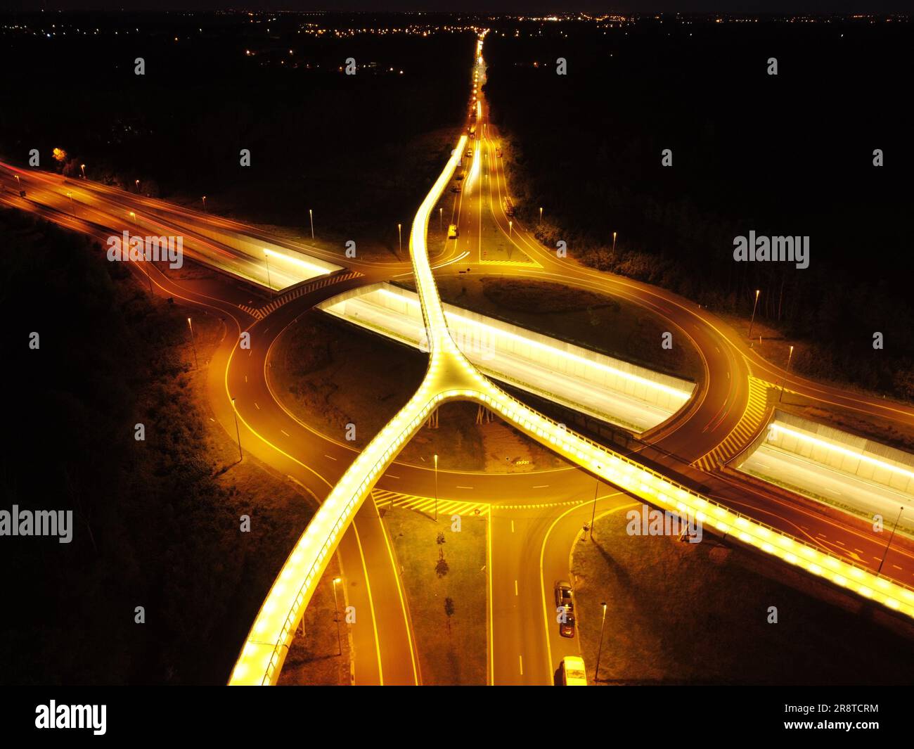 An aerial view of a bustling city illuminated by the night lights ...