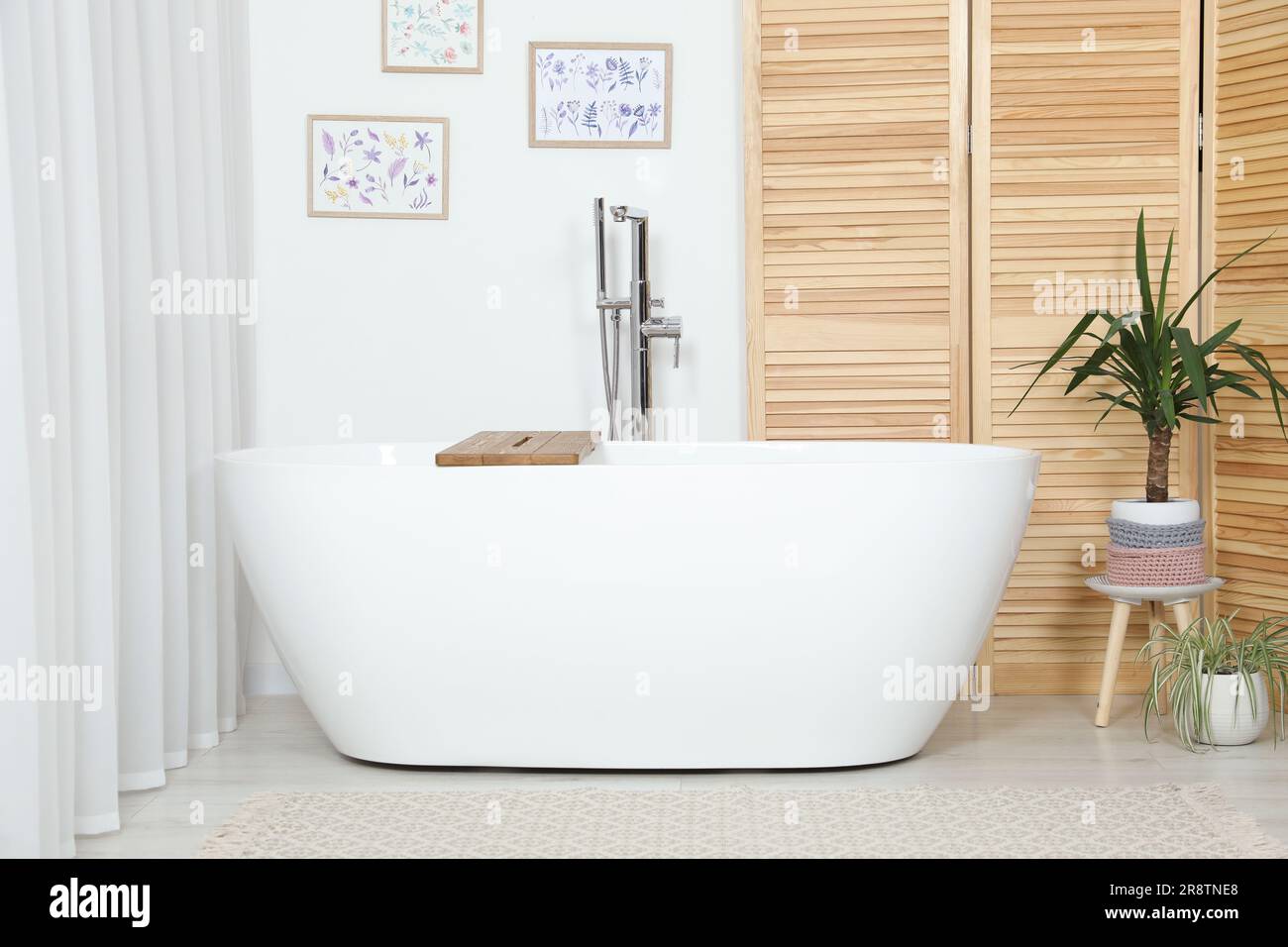 Stylish white tub in bathroom. Interior design Stock Photo - Alamy