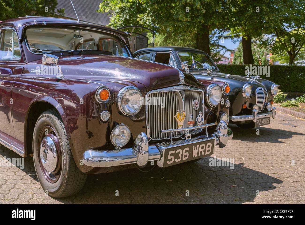 A 1960s Rover P4 luxury saloon parked next to a 1950s Austin A30 family car at a vintage and classic car show. Classic British cars. Stock Photo