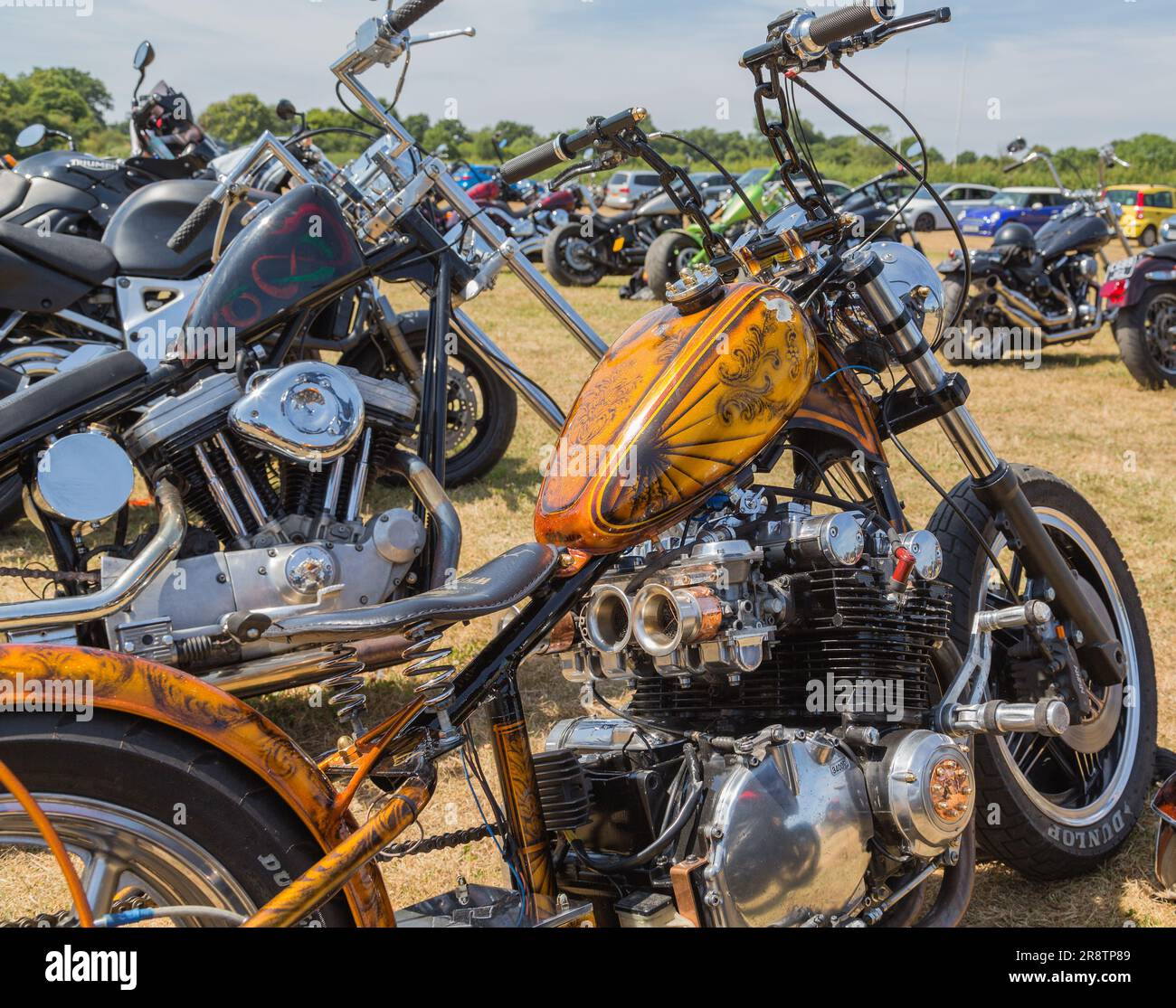 Eye catching choppers stand in line at a motorcycle rally. The chopper