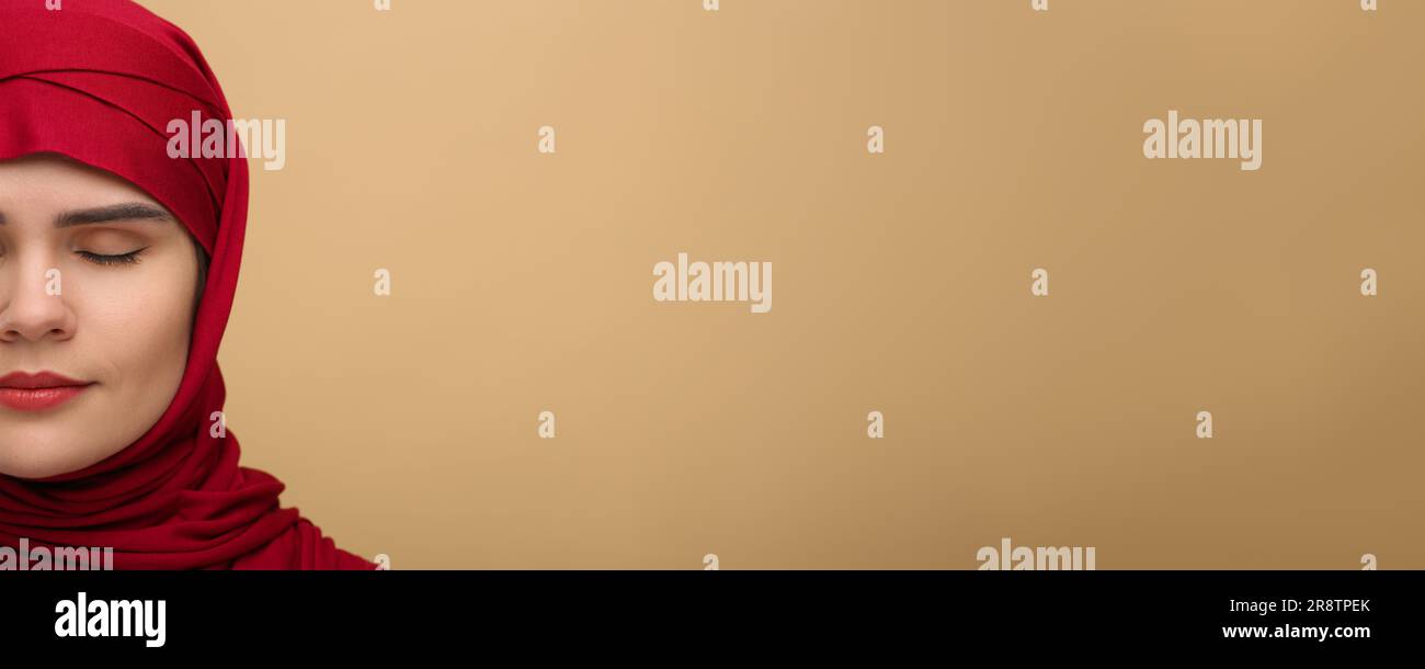 Portrait of Muslim woman in hijab on beige background, space for text ...