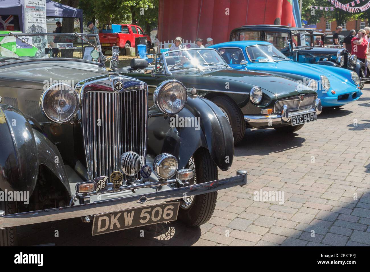 A 1938 MG VA parked alongside an MGB and a Rochdale Olympic at a vintage and classic car show. A line of British classic and vintage cars. Stock Photo