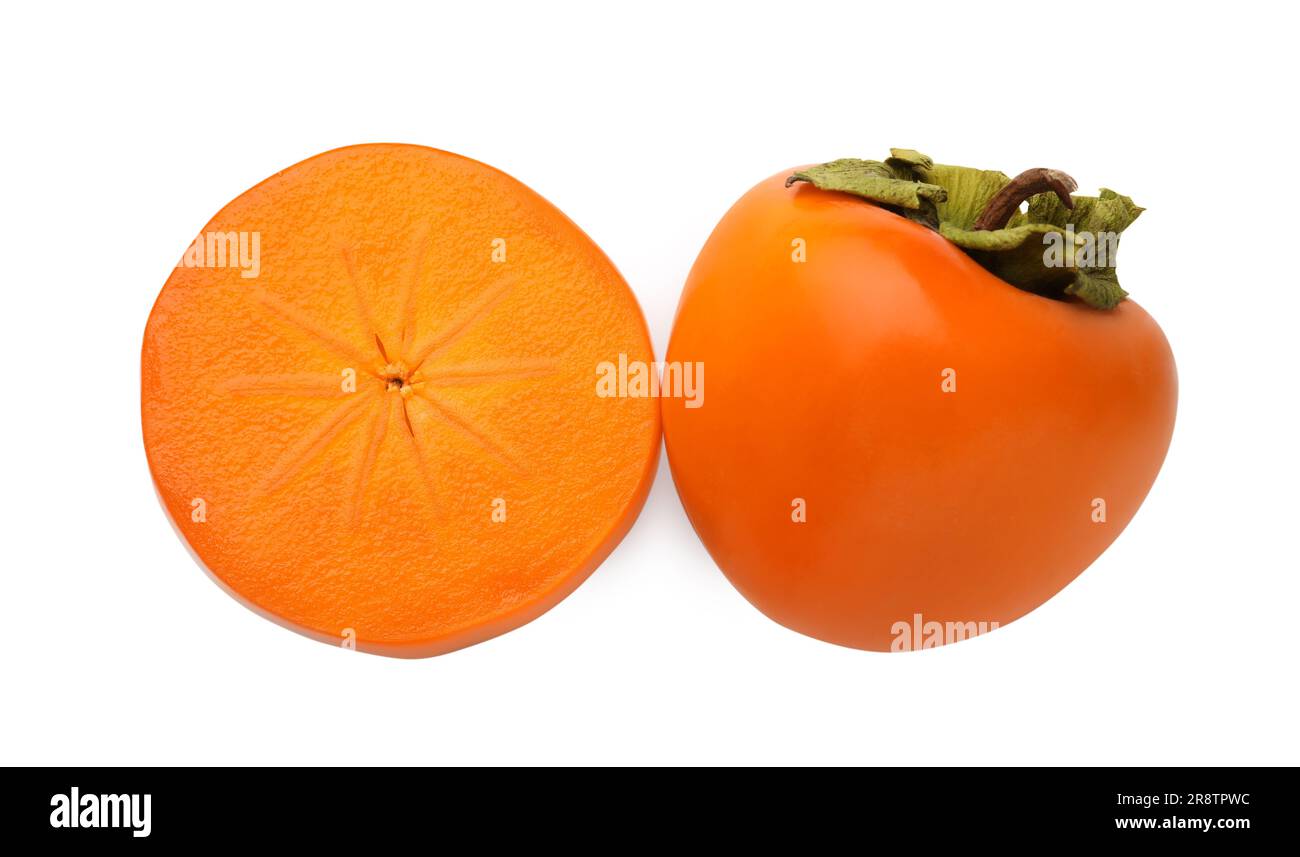 Whole and cut delicious ripe juicy persimmons on white background, top ...