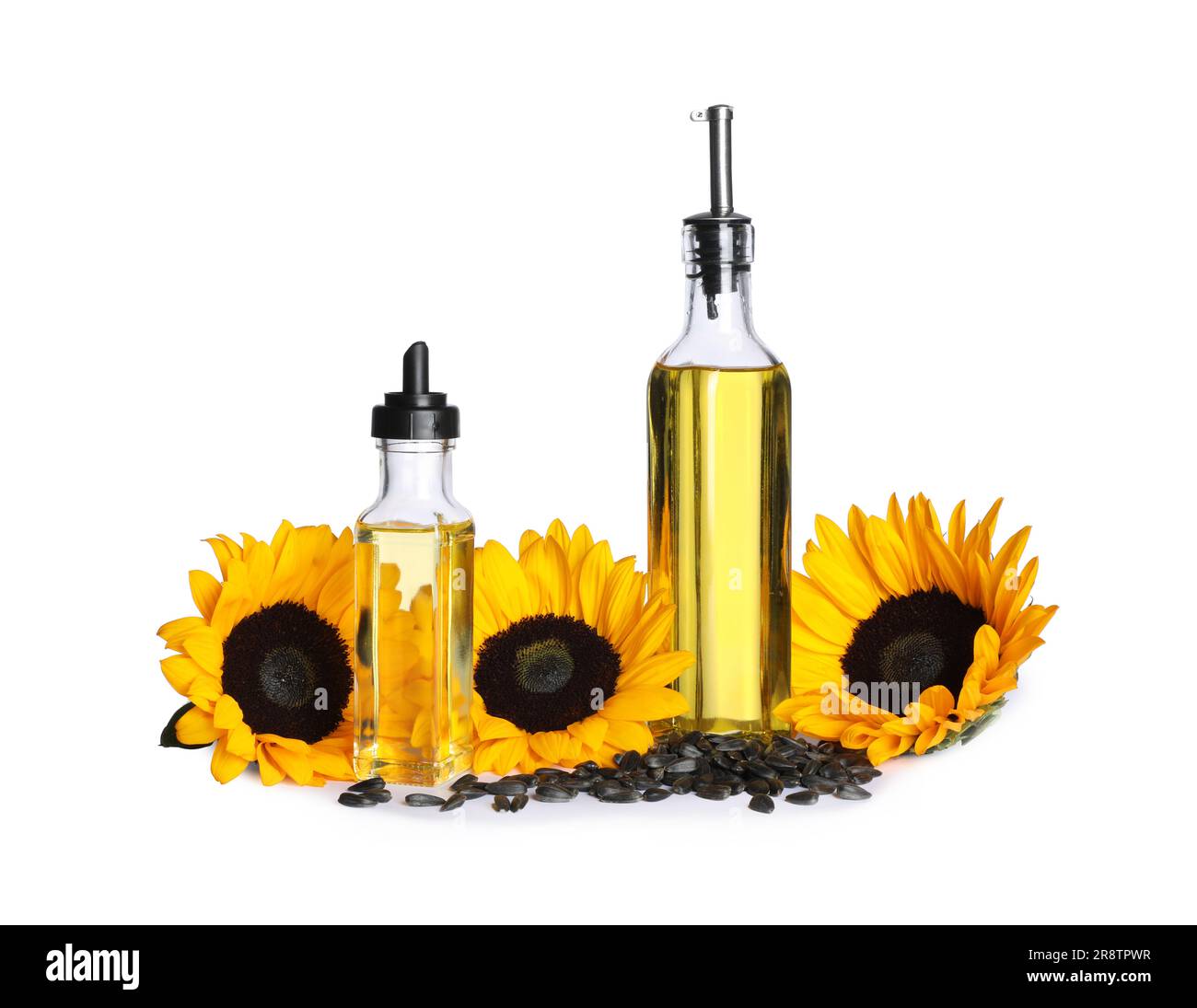 Sunflower cooking oil, seeds and yellow flowers on white background