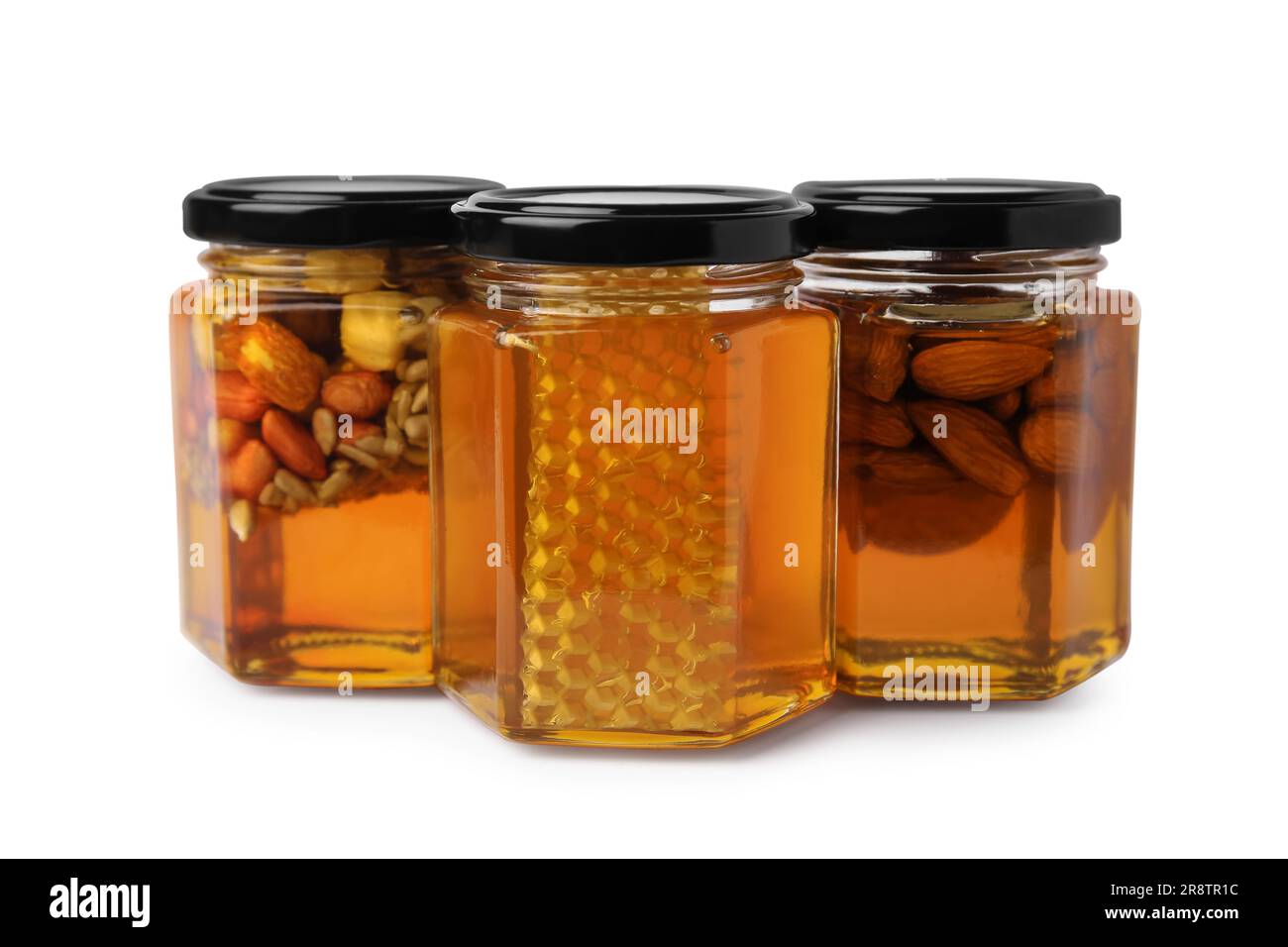 Jars with different nuts and honey on white background Stock Photo