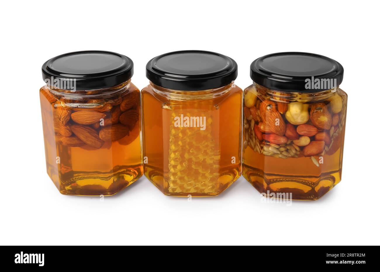 Jars with different nuts and honey on white background Stock Photo