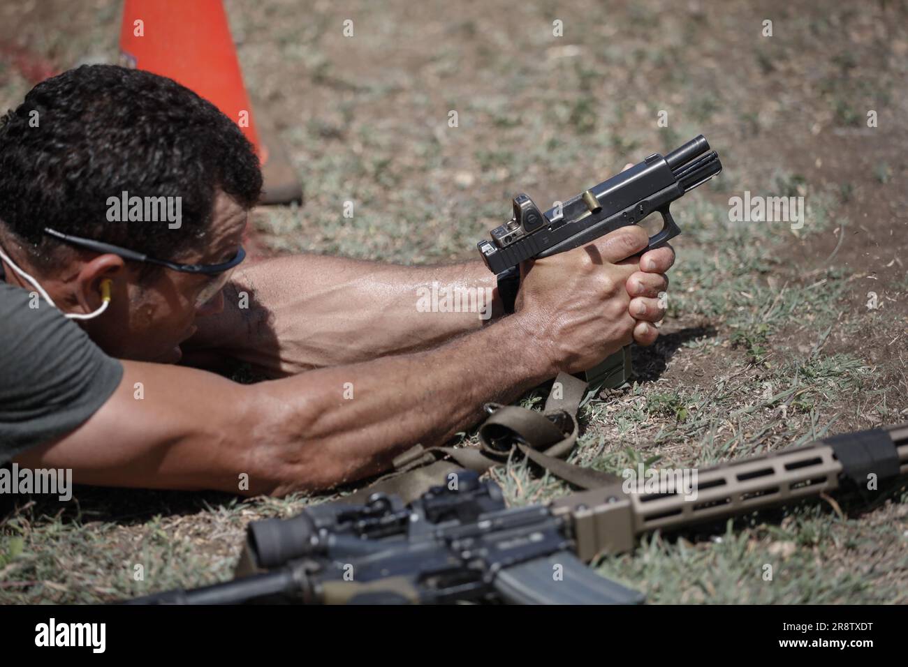 An American special operations team member shoots a pistol during the ...