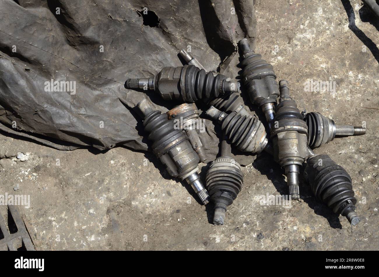 A collage of used auto parts in a barnlike setting with a distressed