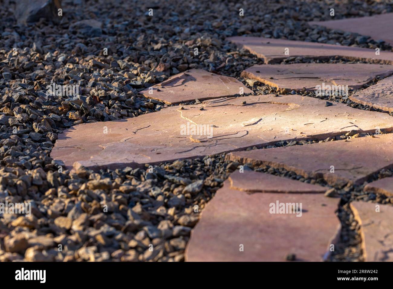 Yard landscape project with flagstone and gravel flooring installed Stock Photo