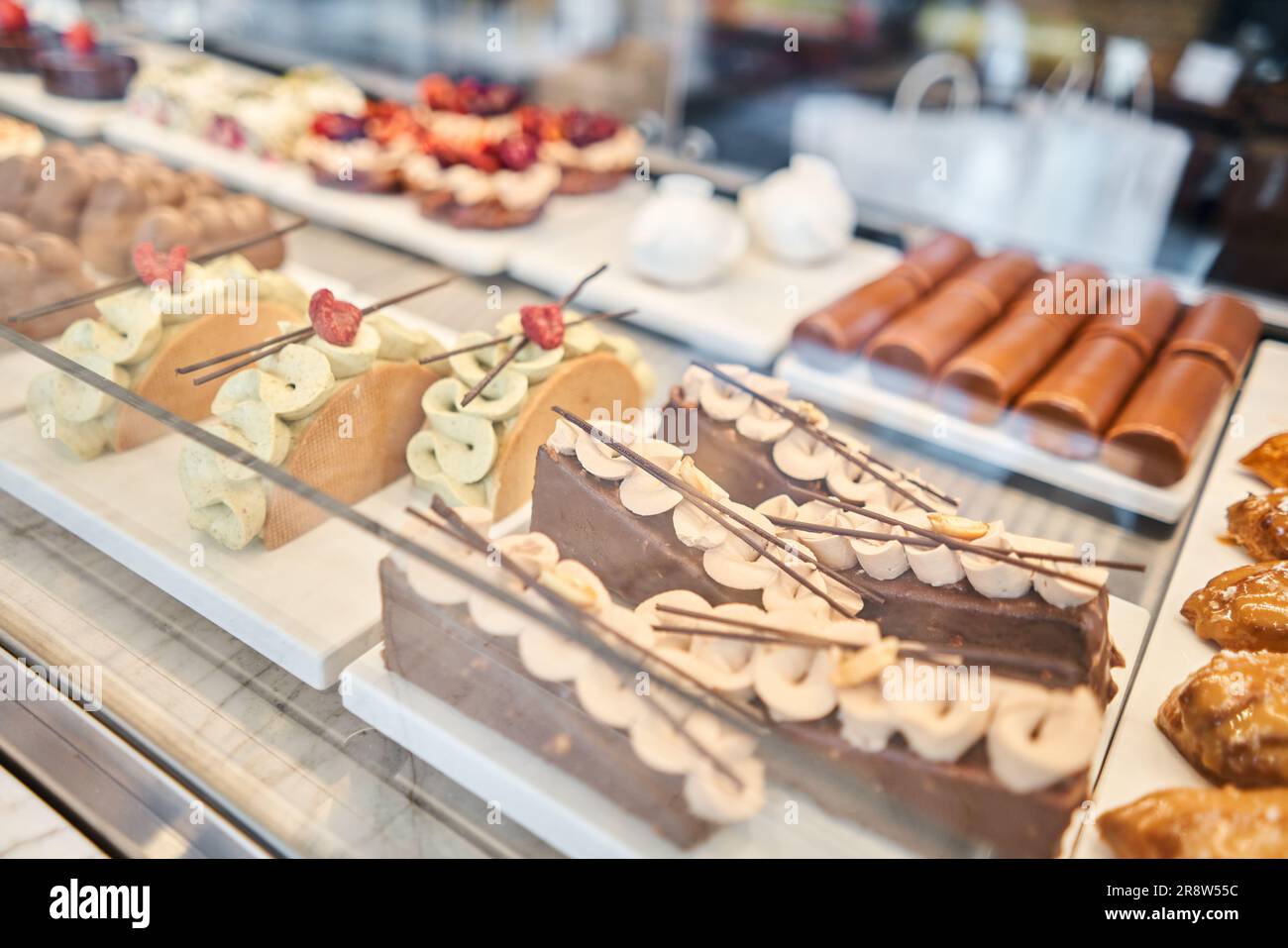 fresh pastries with berries. A variety of fresh pastries in the bakery window. almond croissant