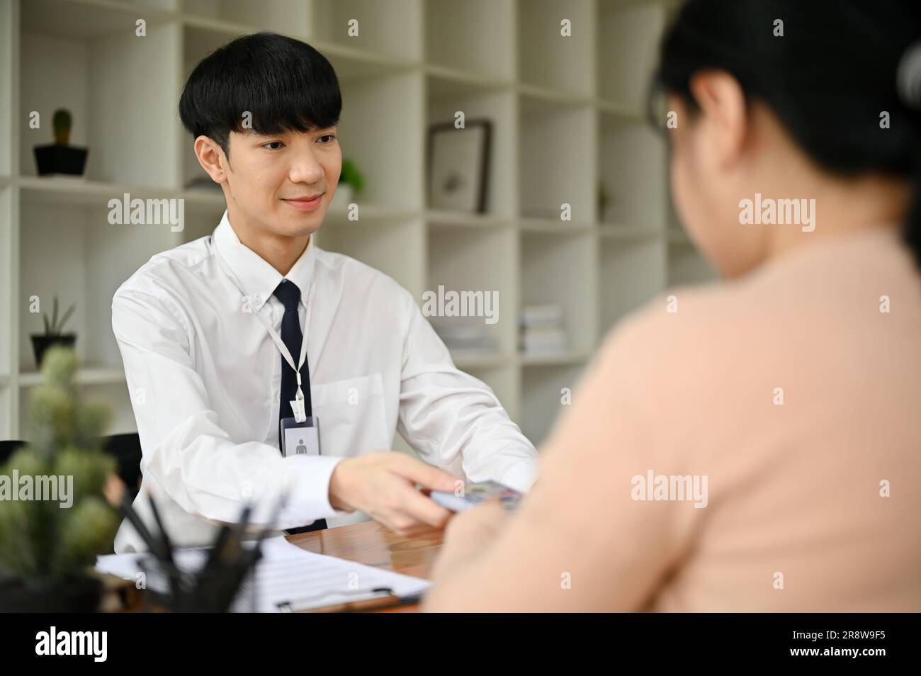 Banker working client table hi-res stock photography and images - Alamy