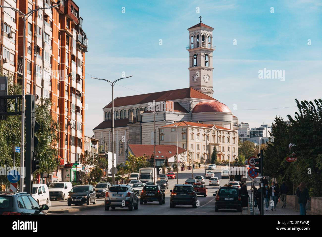 the Roman Catholic Cathedral of St. Teresa in Pristina, Kosovo, stands tall over city traffic. Built in a Romanesque style, completed 2010 Stock Photo