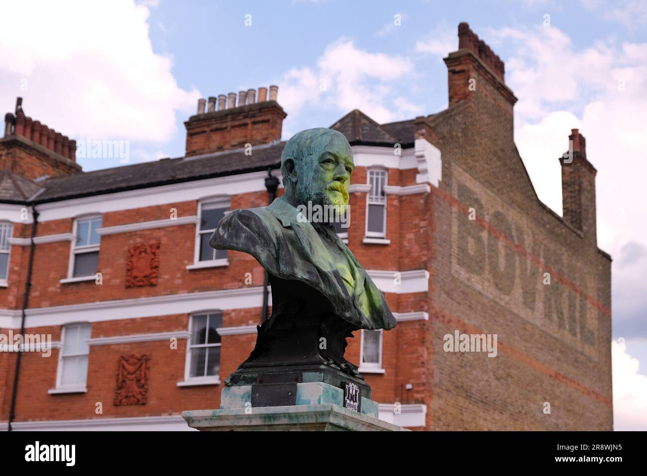 Brixton, UK. A bronze bust of Thomas Tate in Windrush Square is defaced with yellow paint, due to his indirect connection to the slave trade. Stock Photo
