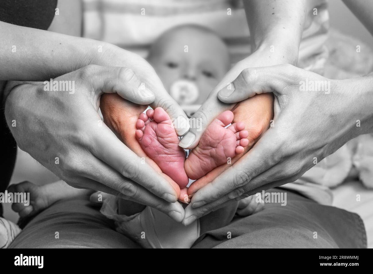 sweet newborn family forming Baby feet heart baby's feet in mom and dad