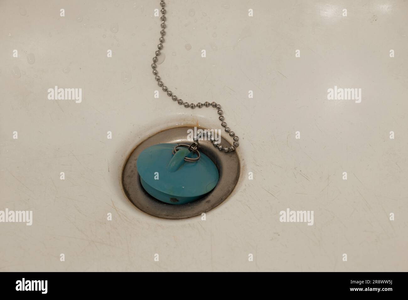 Drainage water with drainage rubber stopper on white shower tub close