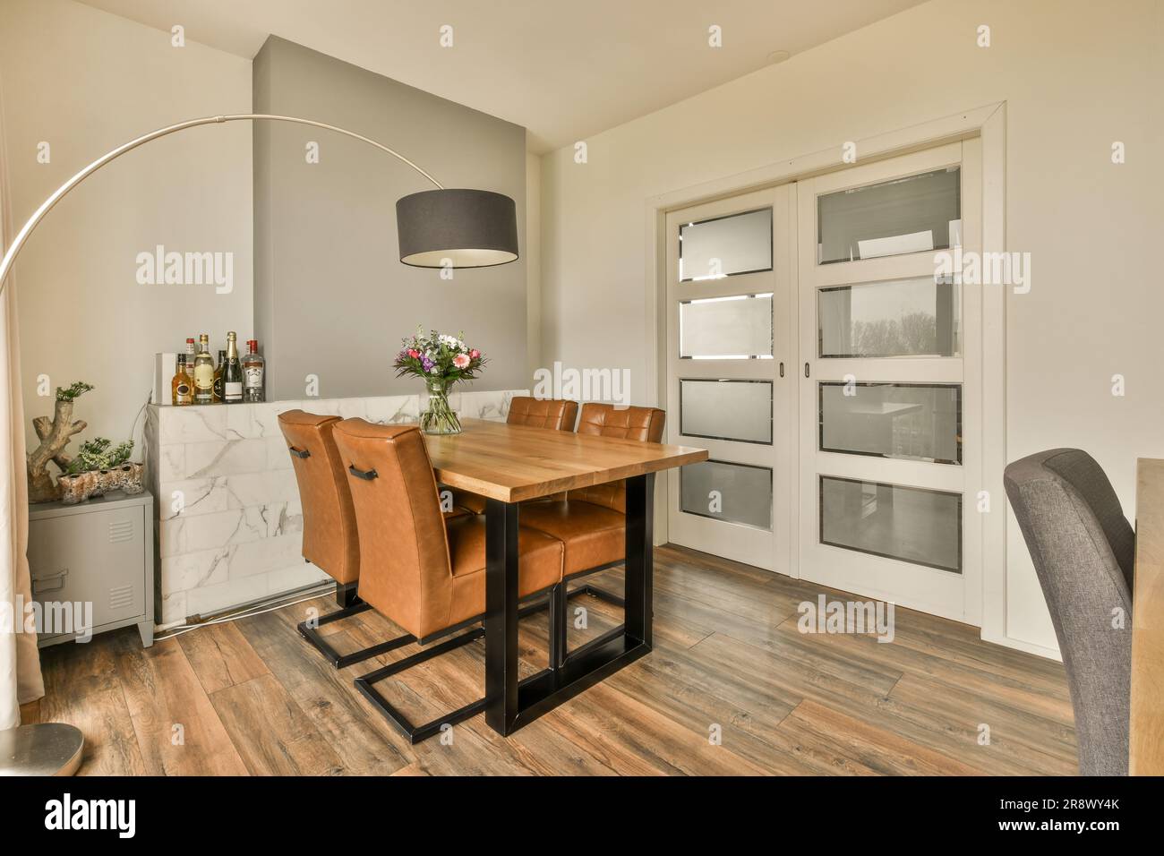 a dining room with wood flooring and white trim around the walls ...