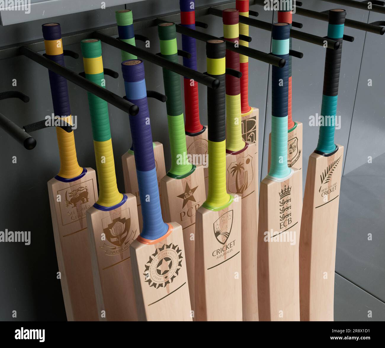 A collection of cricket bats imprinted with gold logos of the ICC