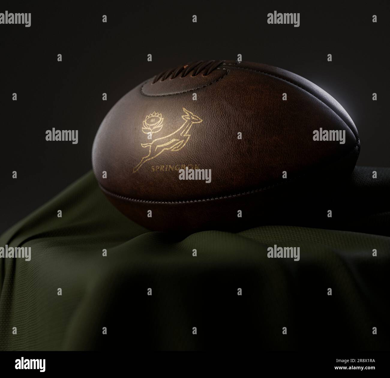 A 3D render of a vintage leather rugby ball with a gold South African rugby logo resting on a draped cloth  - February 13, 2023 in Bristol, United Kin Stock Photo