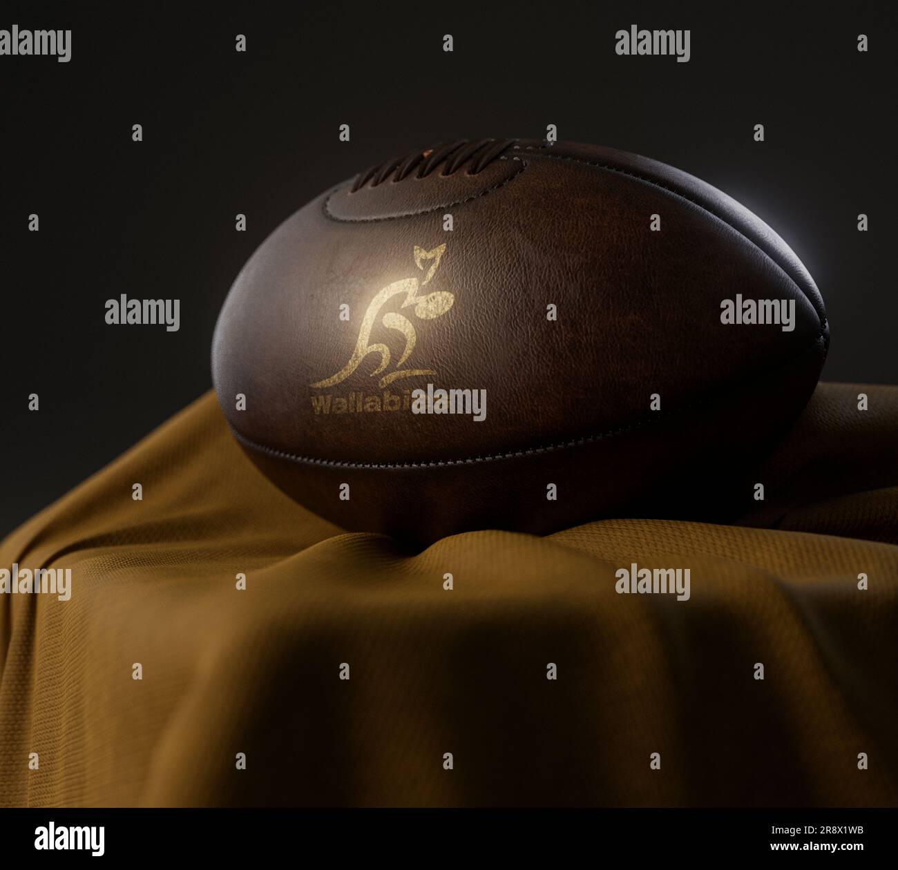 A 3D render of a vintage leather rugby ball with a gold rugby australia rugby logo resting on a draped gold cloth  - February 13, 2023 in Bristol, Uni Stock Photo