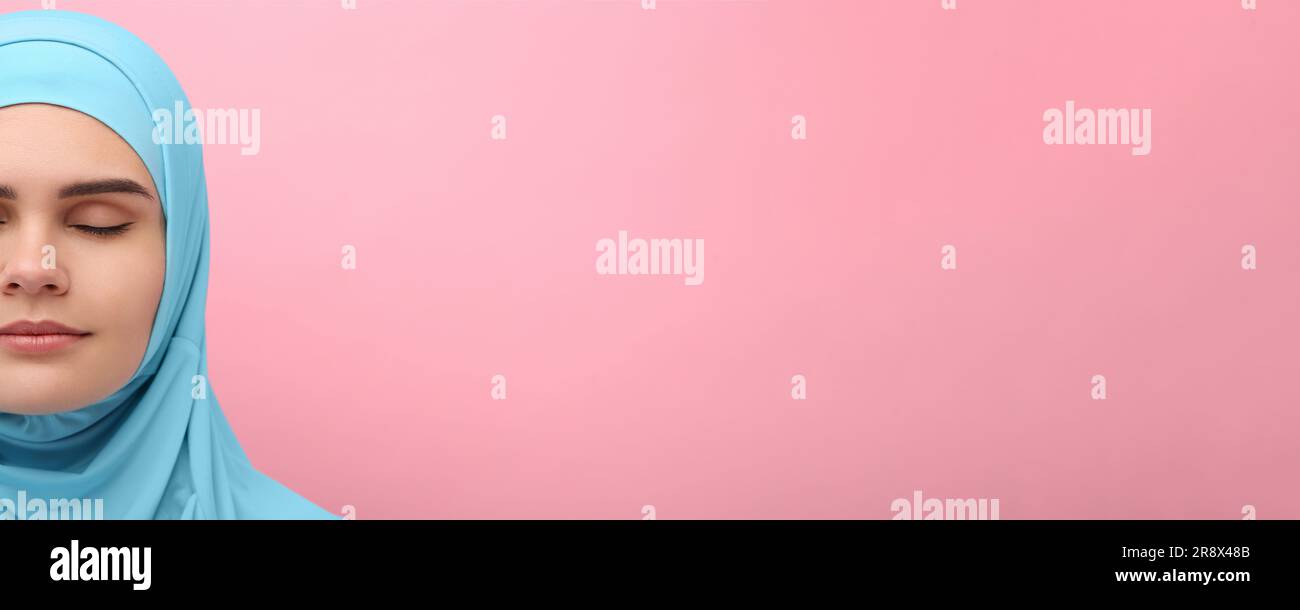 Portrait of Muslim woman in hijab on pink background, space for text ...