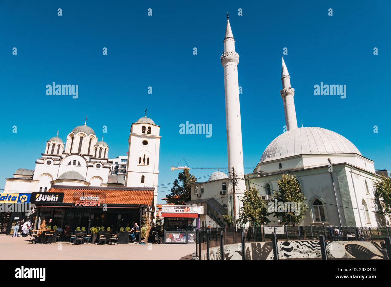 The Great Mosque and Serbian Orthodox St. Uroš Cathedral, which famously neighbor each other in the center of the city of Ferizaj, Kosovo Stock Photo