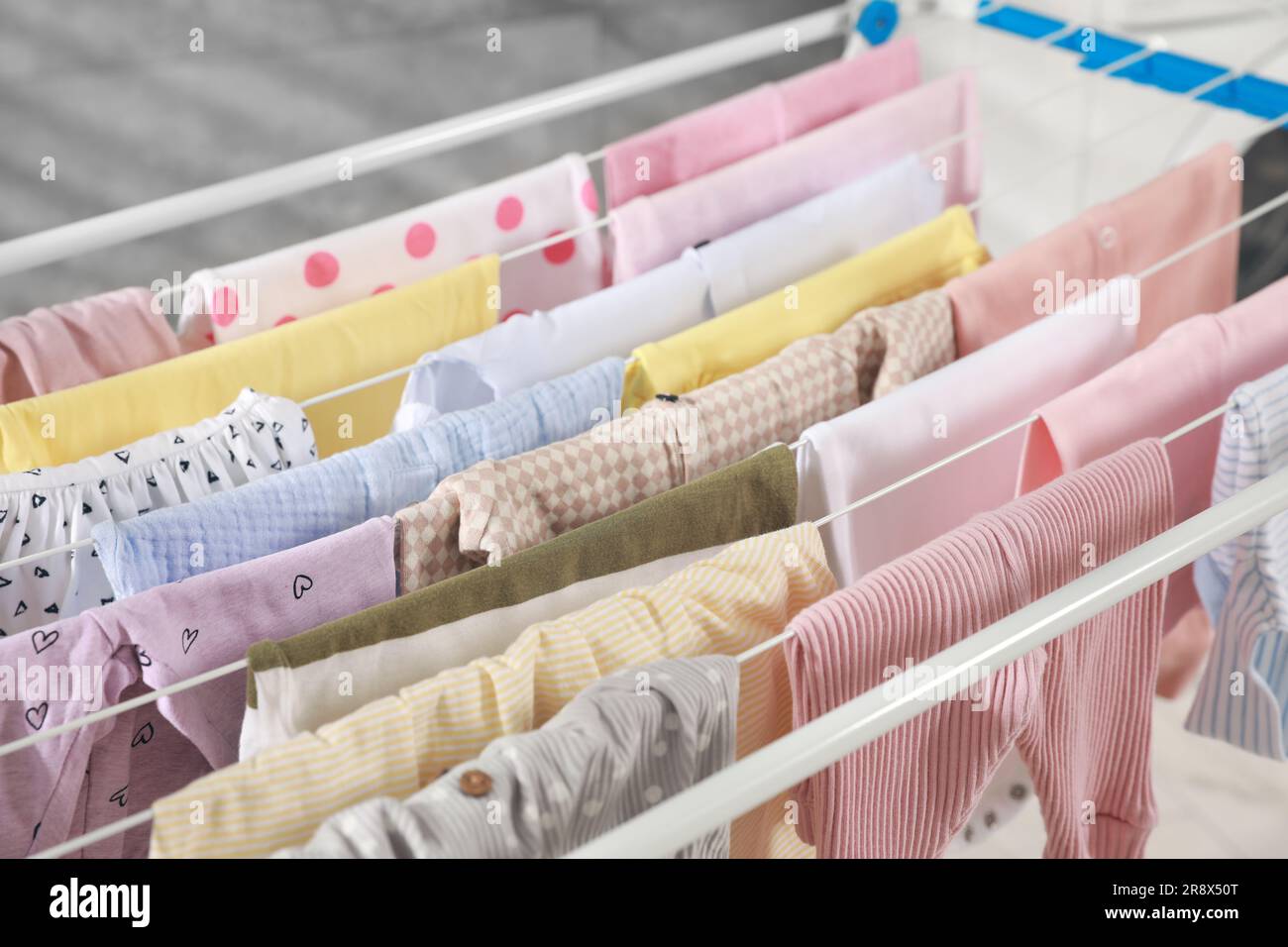 Clean laundry hanging on drying rack, closeup Stock Photo