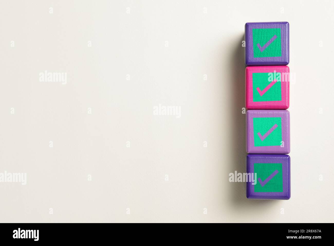 Check Mark Cube Cubes with check marks on beige background, top view. Space for text ...