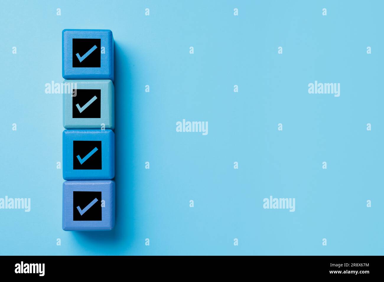 Check Mark Cube Cubes with check marks on light blue background, top view. Space for ...