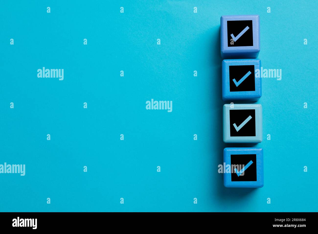 Check Mark Cube Cubes with check marks on light blue background, top view. Space for ...