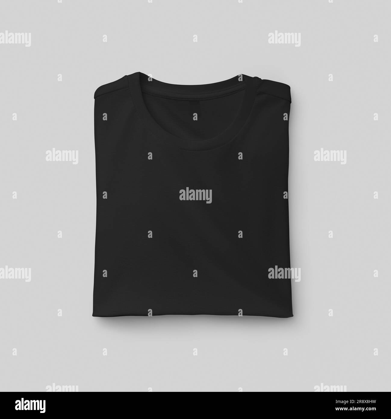 Template of a folded men's black t-shirt with a label, close-up front view, fashion clothes, for design, print. Fashion shirt mockup isolated on backg Stock Photo