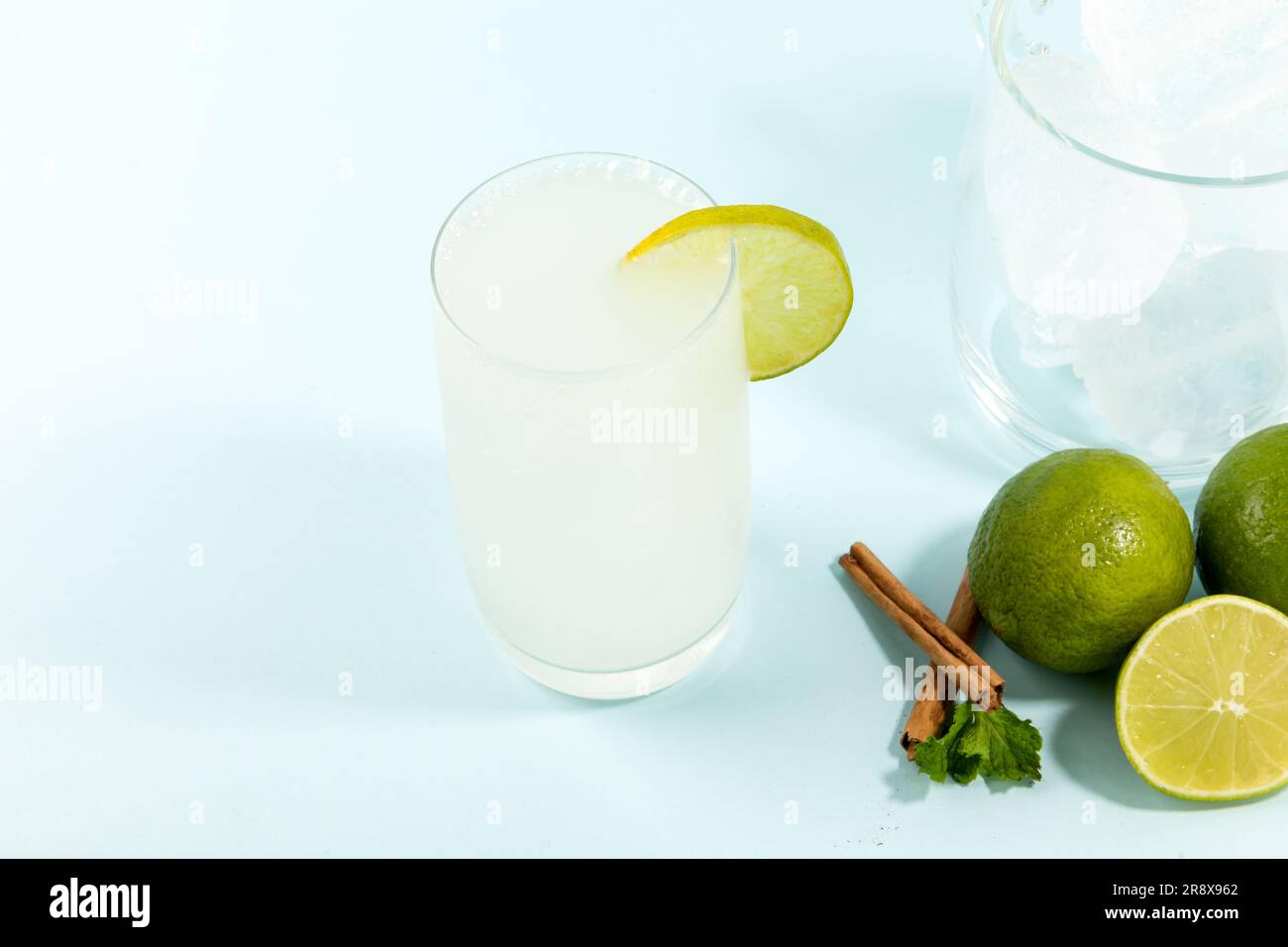 Summer refreshing lemonade drink or alcoholic cocktail on bright cyan ...