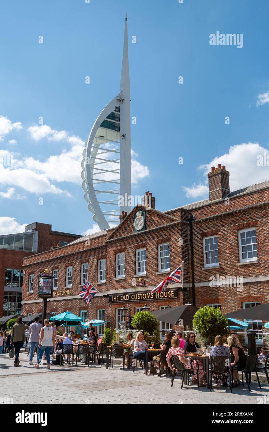 Gunwharf Quays in Portsmouth on a sunny summer June day with people sitting outside the Old Customs House pub, Hampshire, England, UK Stock Photo