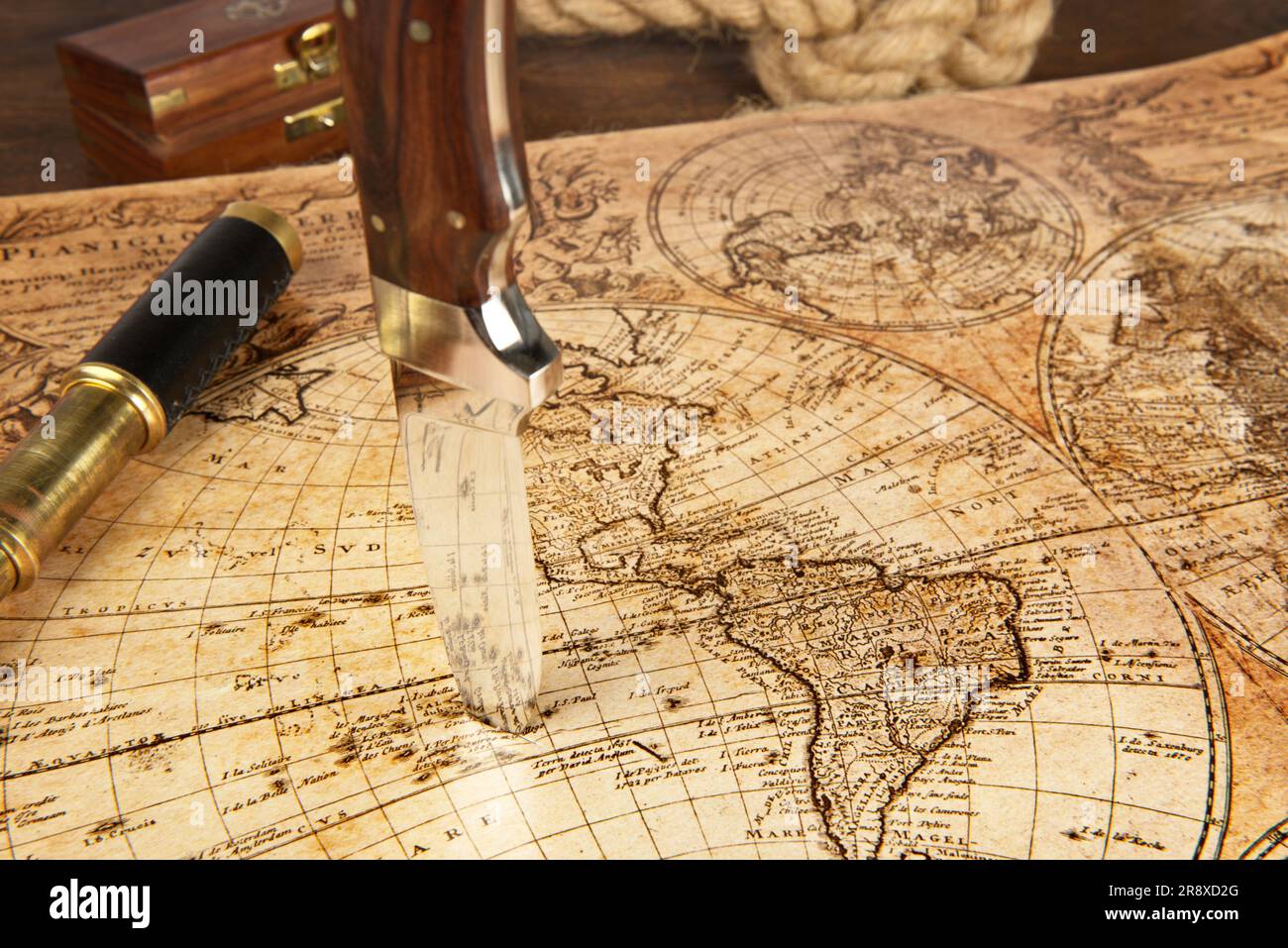 Knife sticking in a old Map to locate the Treasure Stock Photo
