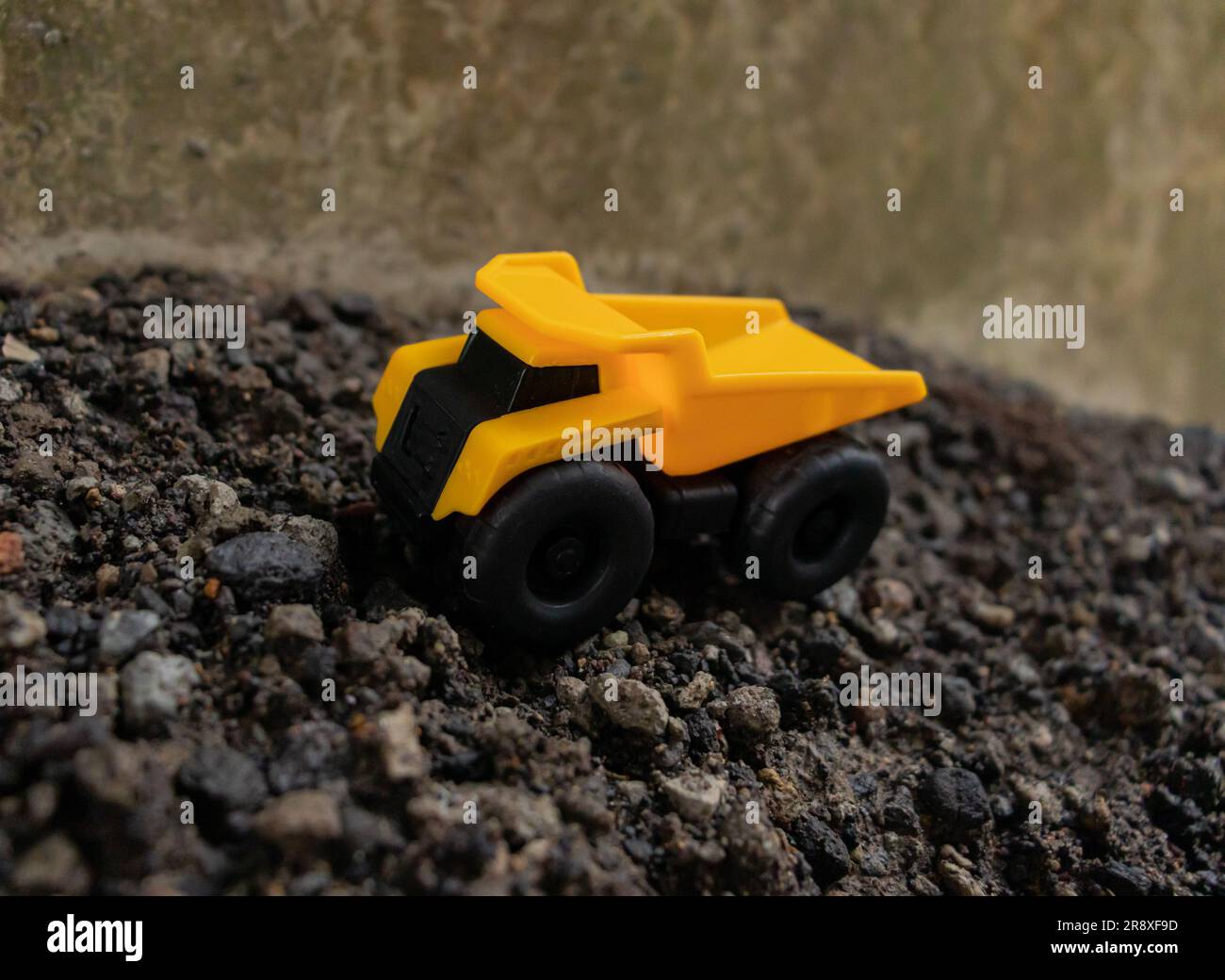 A dump truck on a pile of stones and sand, after some edits. Stock Photo